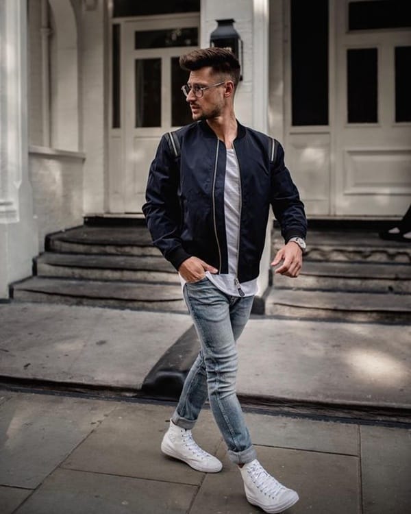 Man in style of bad boy posing on stairs Stock Photo | Adobe Stock